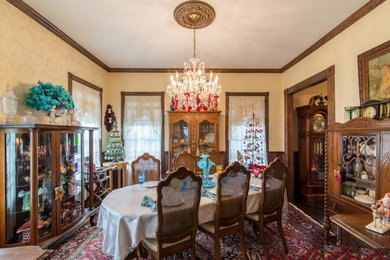 Inspiration for a large victorian enclosed dining room in Austin with beige walls, dark hardwood flooring, no fireplace and brown floors.