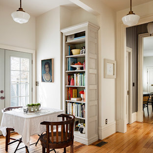 Small ornate medium tone wood floor and brown floor kitchen/dining room combo photo in Portland with white walls and no fireplace