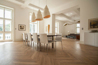 This is an example of a dining room in London with feature lighting.