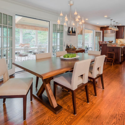 Example of a large classic medium tone wood floor kitchen/dining room combo design in New York with white walls and no fireplace