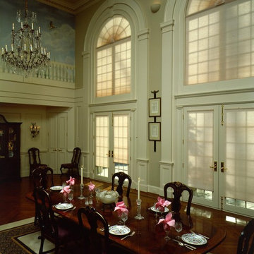 Wall of windows with shades add light &  privacy to a Formal Dining Room