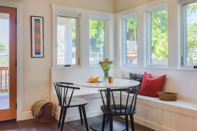 Example of a small classic dark wood floor and brown floor breakfast nook design in Seattle with white walls
