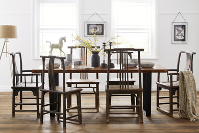 Photo of a world-inspired dining room in London with medium hardwood flooring.
