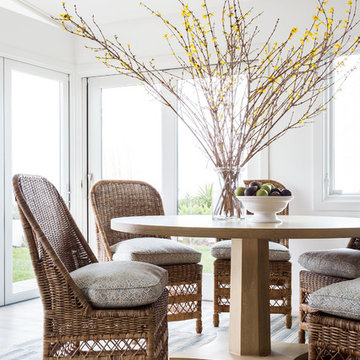Warm Transitional Coastal Dining Room with Woven Chairs