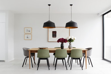Medium sized modern dining room in Dublin with white walls.