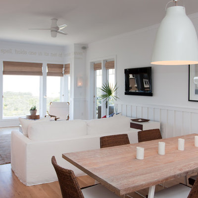 Dining room - coastal dining room idea in Miami with white walls