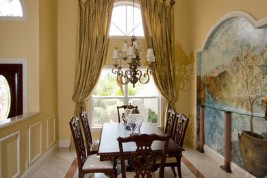 Example of an island style marble floor and beige floor dining room design in Miami