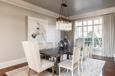 Example of a large transitional dark wood floor, brown floor and tray ceiling dining room design in Charlotte with gray walls