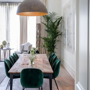 Design ideas for a transitional dining room in Perth with white walls, medium hardwood floors and brown floor.