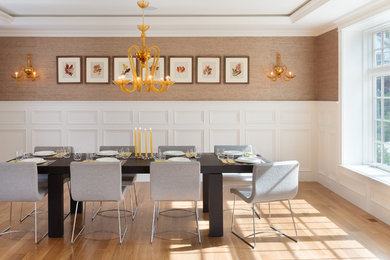 Example of a large trendy light wood floor enclosed dining room design in Boston with beige walls