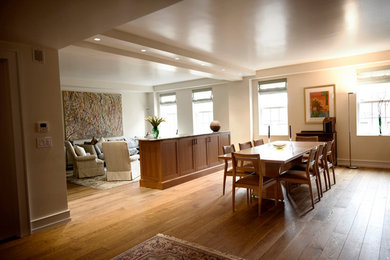 Inspiration for a large timeless medium tone wood floor and brown floor great room remodel in New York with beige walls