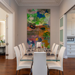 This is an example of a medium sized traditional open plan dining room in London with grey walls, medium hardwood flooring and brown floors.