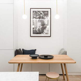 Inspiration for a small scandinavian kitchen/dining room in London with white walls, light hardwood flooring and beige floors.