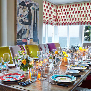 This is an example of a medium sized bohemian dining room in Hampshire with white walls and no fireplace.