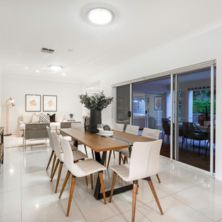 Design ideas for a contemporary open plan dining in Brisbane with white walls and beige floor.