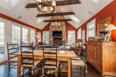Large rustic open plan dining room in New York with red walls, dark hardwood flooring and brown floors.