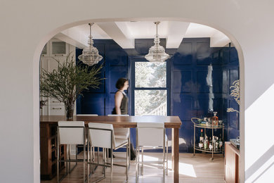 Kitchen/dining room combo - mid-sized transitional light wood floor and brown floor kitchen/dining room combo idea in Minneapolis with blue walls