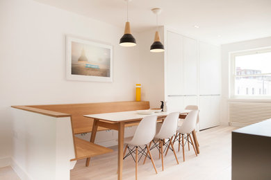 Idée de décoration pour une salle à manger ouverte sur la cuisine nordique de taille moyenne avec un mur blanc, parquet clair et aucune cheminée.