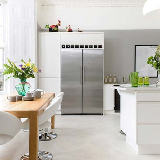 Photo of a medium sized contemporary kitchen/dining room in Other with grey walls, concrete flooring and grey floors.
