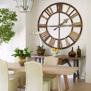 Example of a transitional light wood floor dining room design in New York with white walls