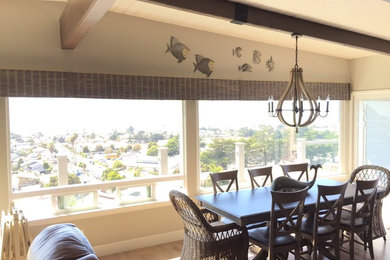 Example of a mid-sized beach style light wood floor and brown floor enclosed dining room design in San Luis Obispo with beige walls and no fireplace