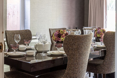 Inspiration for a contemporary dining room in Buckinghamshire with wallpapered walls.