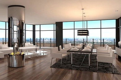 This is an example of a large contemporary enclosed dining room in Los Angeles with black walls, dark hardwood flooring, a hanging fireplace, a metal fireplace surround and brown floors.