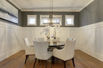 Enclosed dining room - mid-sized transitional medium tone wood floor and brown floor enclosed dining room idea with gray walls