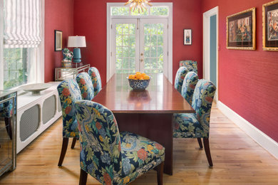 Enclosed dining room - traditional light wood floor enclosed dining room idea in DC Metro with red walls and no fireplace