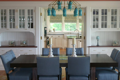 Inspiration for a mid-sized coastal medium tone wood floor enclosed dining room remodel in Boston with white walls