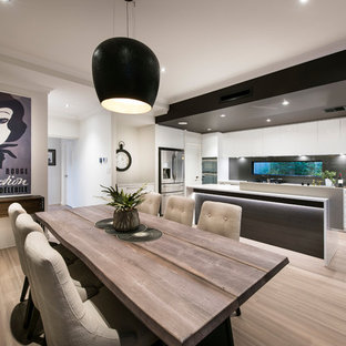 This is an example of a large contemporary open plan dining in Perth with white walls and light hardwood floors.