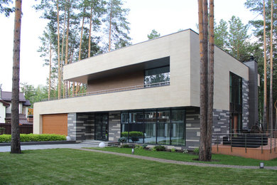 На фото: двухэтажный частный загородный дом среднего размера в современном стиле с плоской крышей с