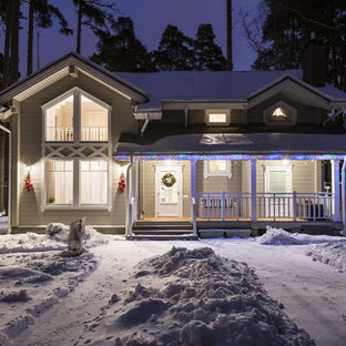 Design ideas for a small classic two floor house exterior in Moscow with wood cladding.