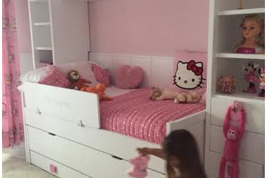 This is an example of a medium sized traditional toddler’s room for girls in Malaga with pink walls.