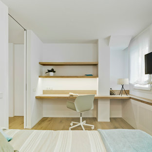 Ejemplo de dormitorio infantil contemporáneo, de tamaño medio, con escritorio, paredes blancas y suelo de madera clara