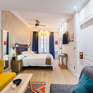 Design ideas for a large eclectic master bedroom in Bilbao with white walls, light hardwood flooring and no fireplace.