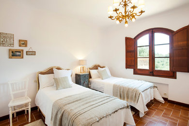 Rustic guest bedroom in Barcelona with white walls.