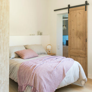 Inspiration för ett mellanstort medelhavsstil gästrum, med vita väggar, ljust trägolv och beiget golv