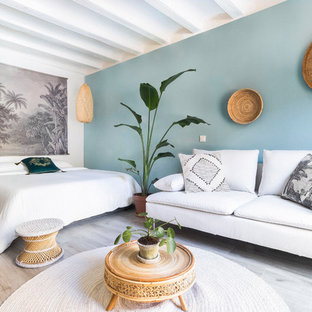 Foto de dormitorio principal, tropical, sin chimenea, con paredes azules y suelo beige