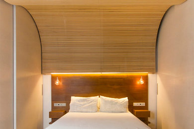 Example of a mid-sized trendy master bedroom design in Madrid with beige walls and no fireplace