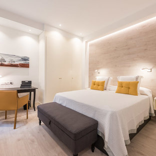 Medium sized traditional master bedroom in Madrid with white walls, light hardwood flooring and no fireplace.
