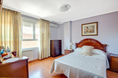 Imagen de dormitorio principal tradicional extra grande con paredes azules, suelo de madera en tonos medios, suelo marrón y bandeja