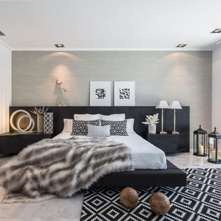 Photo of a large contemporary master bedroom in Valencia with grey walls, marble floors and no fireplace.