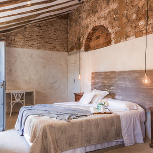 Imagen de dormitorio mediterráneo con paredes beige, suelo de cemento y suelo gris
