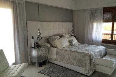 Ejemplo de dormitorio principal tradicional renovado de tamaño medio sin chimenea con paredes grises, suelo de madera clara y suelo blanco