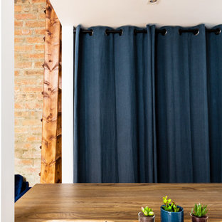 Foto di una piccola cabina armadio unisex industriale con nessun'anta, ante blu, pavimento in legno massello medio e pavimento marrone