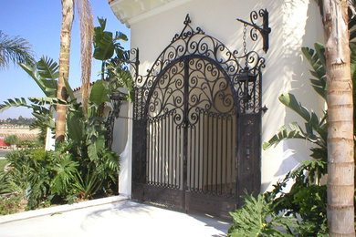Large tuscan front door photo in Santa Barbara with beige walls