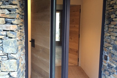 Ejemplo de vestíbulo contemporáneo de tamaño medio con puerta pivotante y puerta de madera en tonos medios