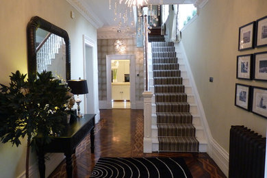 This is an example of a large traditional hallway in Cheshire with dark hardwood flooring.