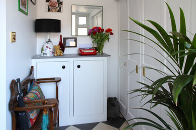 Inspiration for a small bohemian foyer in Kent with white walls and porcelain flooring.